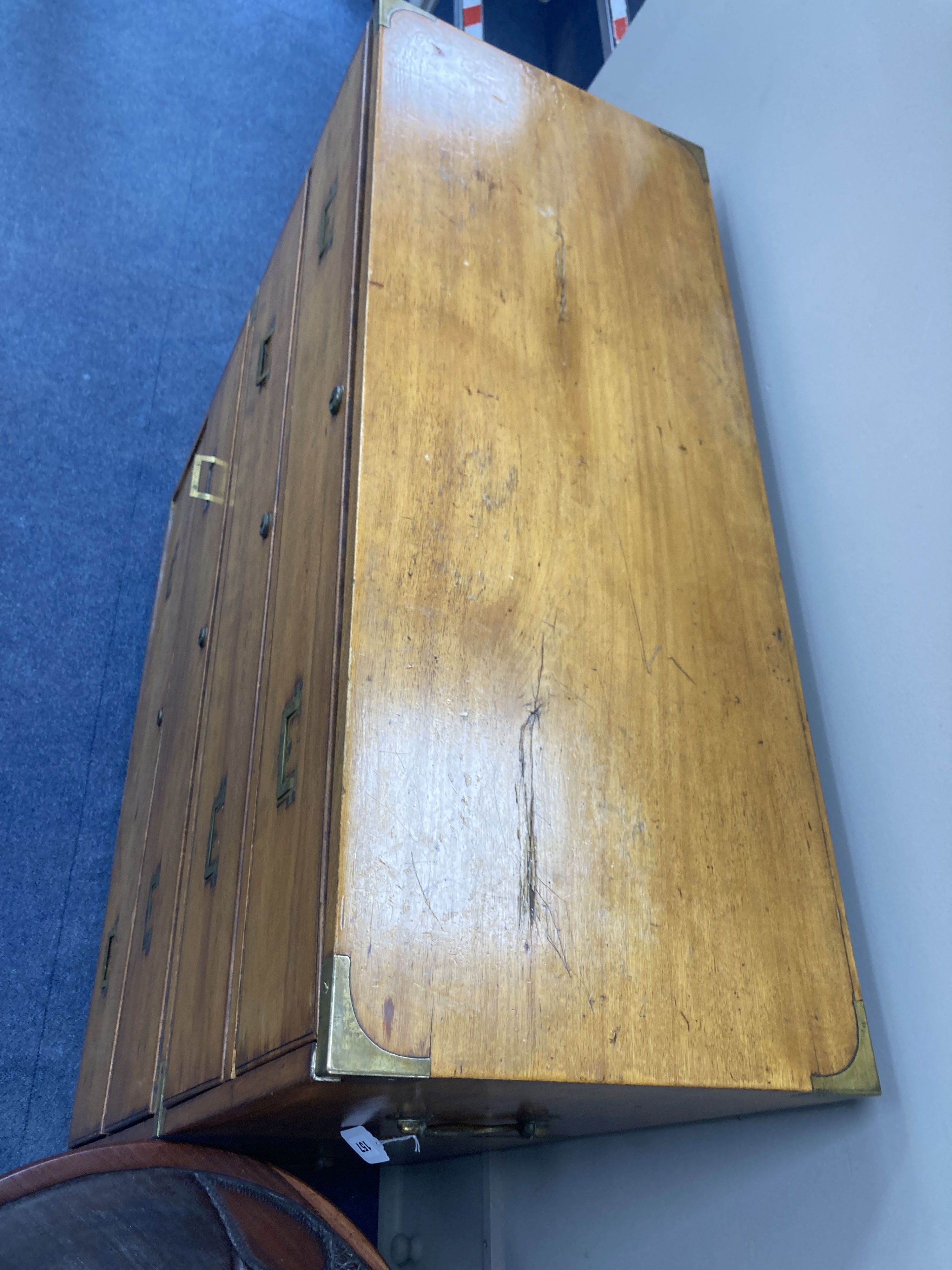 A 19th century two sectional fruitwood campaign chest, of four long drawers, brass capped with flush fitting handles and further carryi